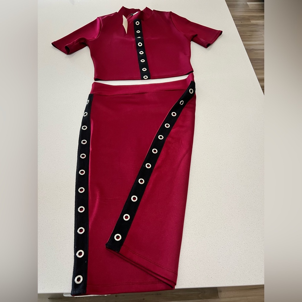 Woman 2 piece skirt set. The colors are maroon and black.
